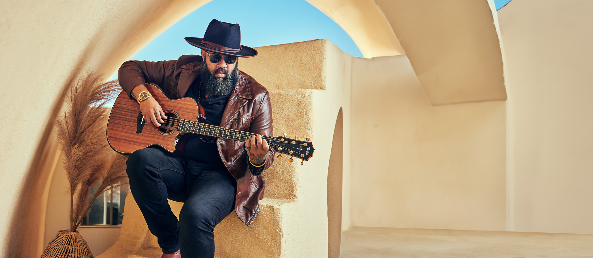 Man Sitting on steps playing beautiful guitar