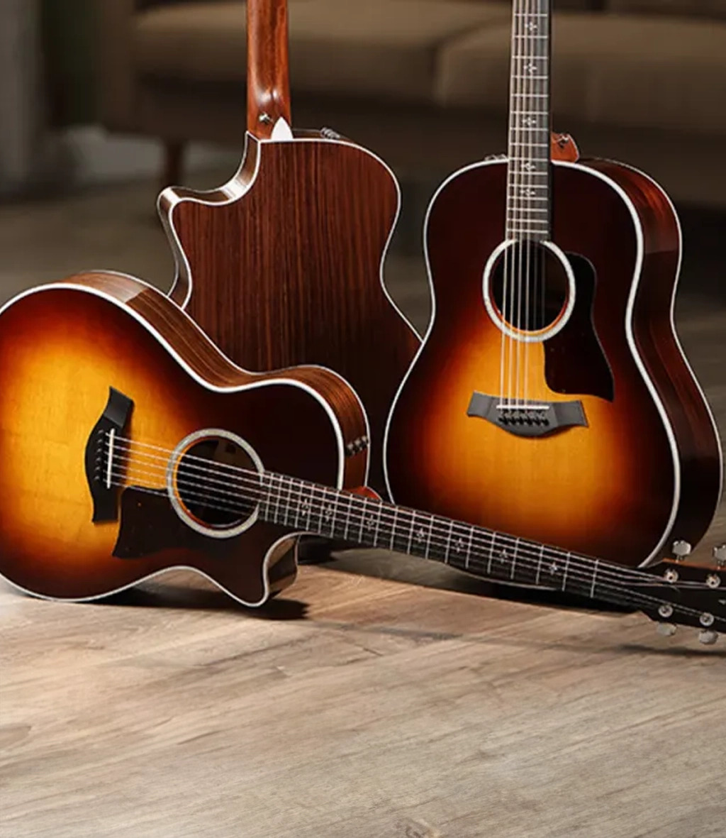 Three guitars grouped together on wooden floor