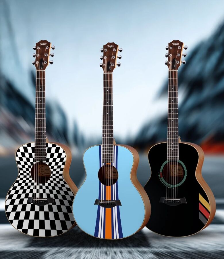 Three Taylor guitars in Porsche Club of America designs on a racetrack, with the PCA and Taylor logos